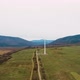 Lonely windmill in the field between Carpathian mountains of Ukraine in spring against a background - VideoHive Item for Sale