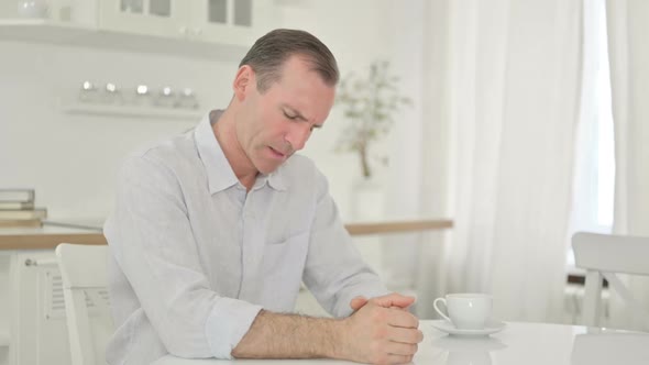 Stressed Middle Aged Man Getting Worried at Home