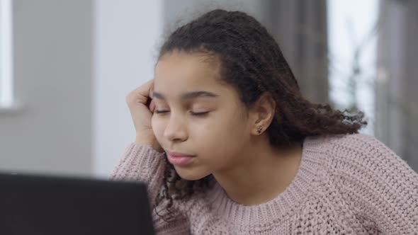 Closeup Portrait of Bored Tired African American Pretty Girl Falling Asleep in Front of Laptop