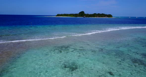 Daytime aerial copy space shot of a white sandy paradise beach and aqua turquoise water background i