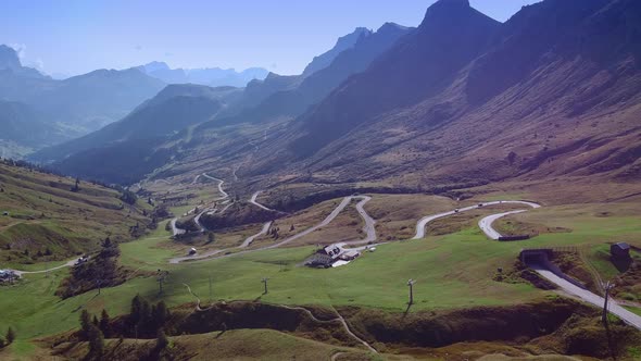 Breathtaking View of Dolomites Mountains, Waving Road and Valley in Sun Light