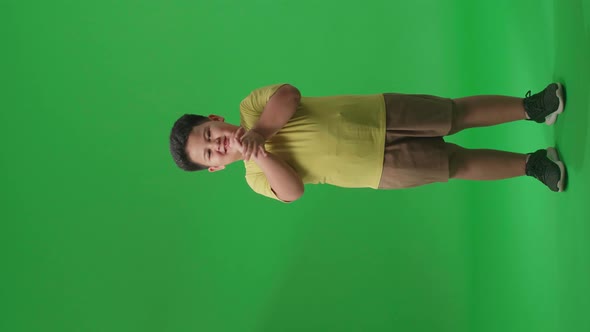 Full Body Of Asian Little Boy Clapping His Hands In The Green Screen Studio