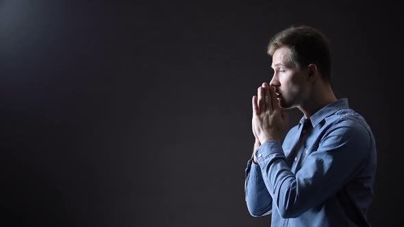 Young Male Praying, Blessing God Under Light From Heaven, Christianity Sign