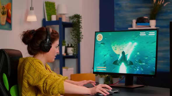 Gamer Woman with Headphones Playing Space Shooter Video Game