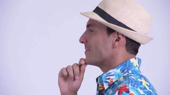 Closeup Profile View of Young Happy Hispanic Tourist Man Thinking