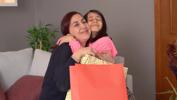 Child giving gift to mother.