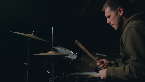 Man Sits Down To Play the Drum Set