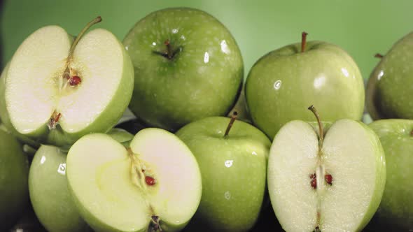 Slow Motion Shot of Green Apple Juice Splashing Through Apple Slices