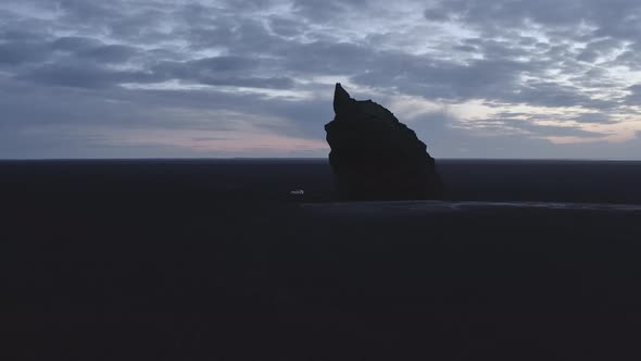 Silhouette of Arnardrangur Sea Stack in an Aerial View at Dawn in Iceland