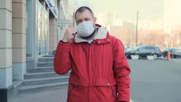 Happy Positive Cured Man Takes Off His Medical Mask of Coronavirus Protection Outside. Health and