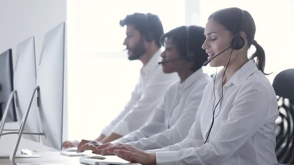 Call Center Agents Consulting Clients On Hotline At Office