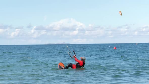 Athlete Showing Sport Trick Jumping with Kite and Board in Air. Extreme Water Sport and Summer