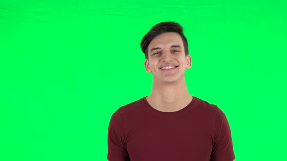 Guy Smiling While Looking at Camera and Flirting. Green Screen