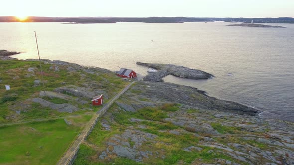 Rocky Seawall At The Island Of Store Torungen During Golden Sunset In Agder County, Norway. wide sho