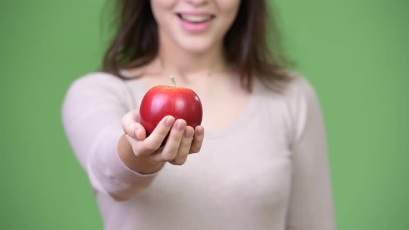 Young Happy Beautiful Woman Holding Apple