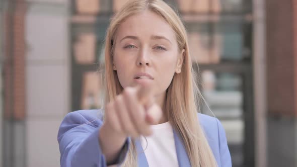 Young Businesswoman Pointing with Finger Outdoor