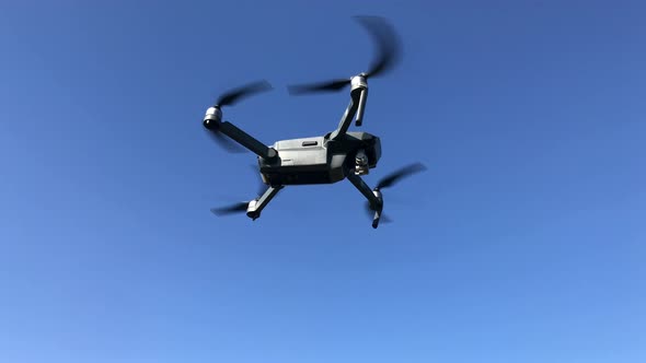 Drone flying in the sky, small quadcopter