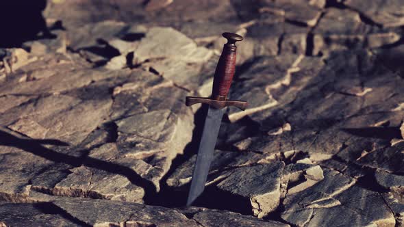 Excalibur Sword in Rocky Stone at Sunset
