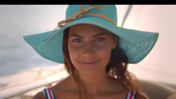 Close Up Shot of Pretty Tanned Woman in Blue Straw Hat She Enjoys Her Vocation at Sea Boat