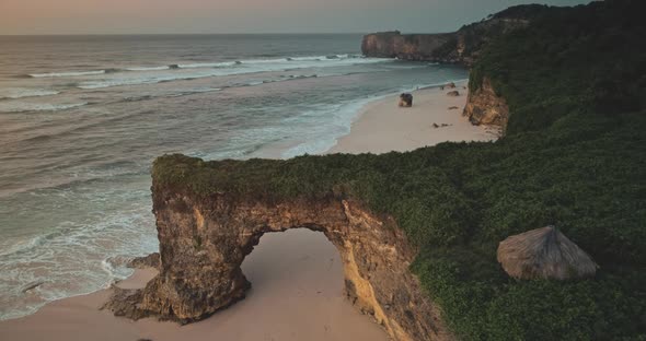 Indonesia Tourist Attraction Closeup Aerial Giant Hole on Cliff Wall of Batu Bolong Bawana Beach