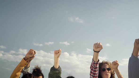 Group of People Hands Raised in a Protest Participating in a Nonviolent March