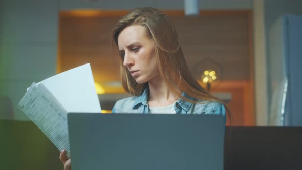 A Beautiful Woman Is Working at the Notebook at Home