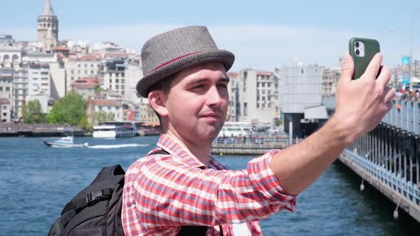 Tourist Man Holding Smartphone and Talking Video Selfie Touristic Places Outdoor Travel Blogger