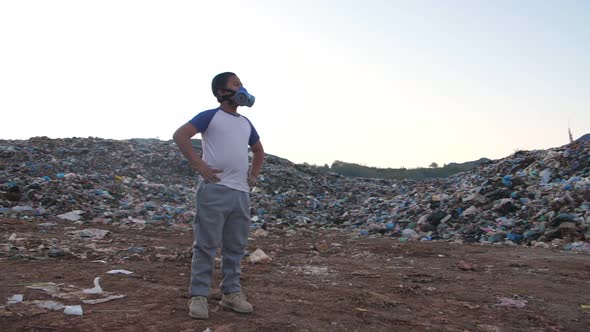 Asian Boy Wearing Pollution Mask Standing With Garbage Pile