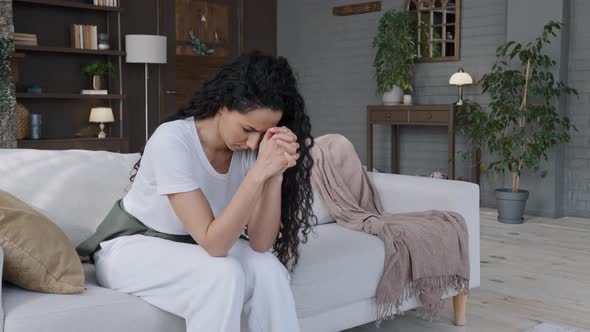 Excited Frustrated Stressed Young Woman Sitting in Room on Couch Thought Sadly Learned Bad News