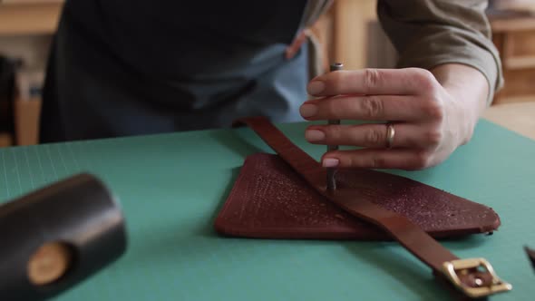 Currier Making Hole in Handmade Leather Belt