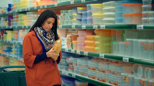 Woman in Red Coat Shopping in Supermarket