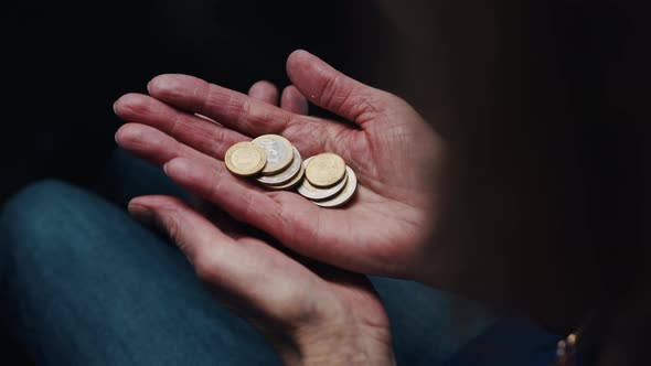 Old Woman Counting Coins in Her Wrinkled Hands