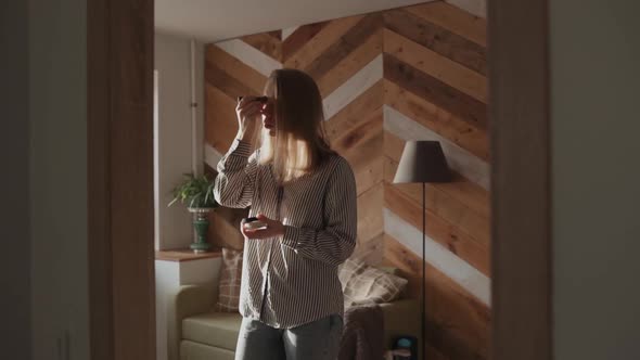 Girl Doing Makeup Standing in Front of the Mirror