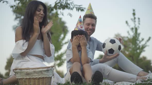 Happy Little Boy Party Hat Sitting Closed Eyes Cheerful Father Mother Giving Soccer Football Ball