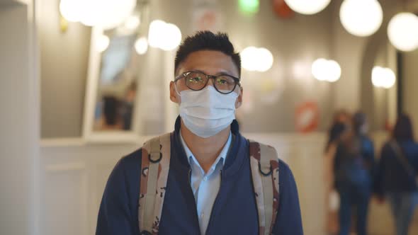 Portrait of Young Asian Student Wear Mask Walking in University Building