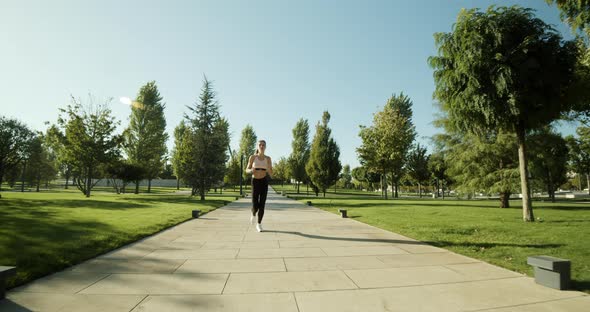 Active Fitness Woman Runner Jogging in Sunny Street Summer Day Outdoors