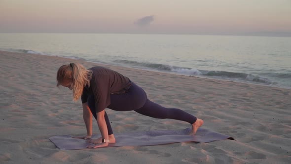 Yoga teacher performing yoga moves on the beach
