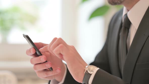 Close Up of Hands of Middle Aged Businessman Using Smartphone Mobile