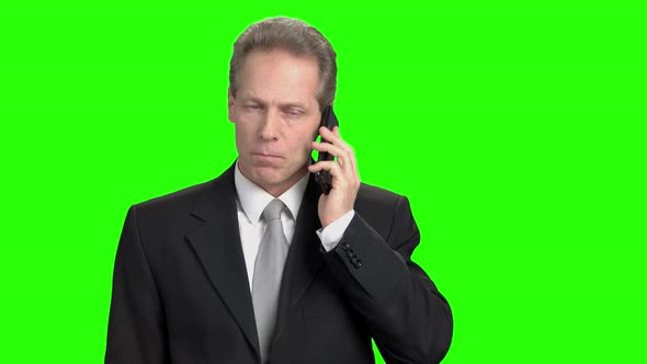 Cheerful Mature Businessman Talking on Phone