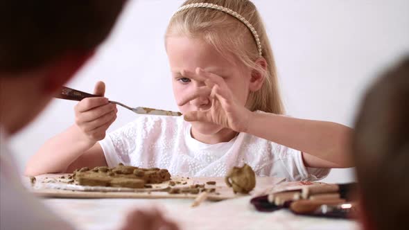 Portrait of Kid Girl is Modeling Toys From Clay