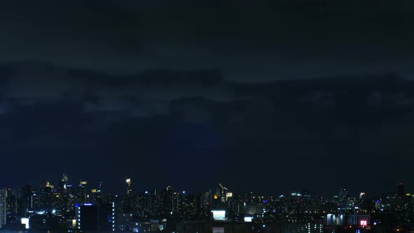 Time lapse raining storm lightning in cityscape at night