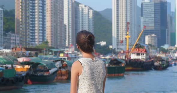 Tourist woman enjoy the view of Hong Kong city with seaside