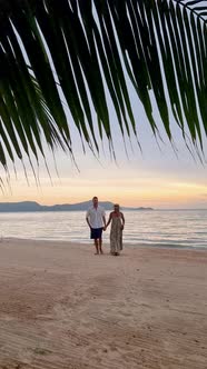 Men and Women Walking on the Beach in Pattaya During Sunset in Thailand Ban Amphur Beach