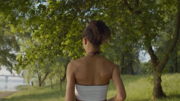 Female Athlete Running on Park Alley at Sunrise