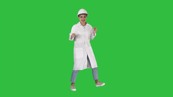 Engineer woman dancing in funny way on a Green Screen, Chroma Key.