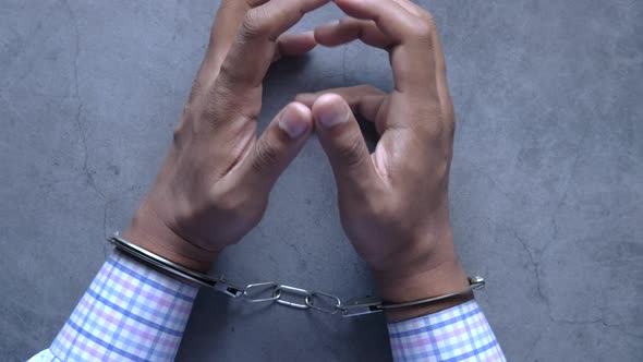 Hands of a Man with Handcuffs Close Up.