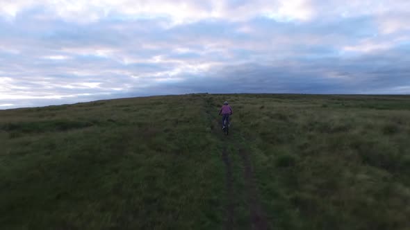 Aerial shot of a mountain biker on a singletrack trail.