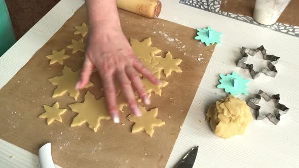 A Woman Works With Snowflake Cookie Dough.