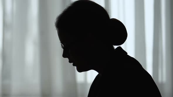 Silhouette of Tired Woman Holding Head, Overworked and Depressed, Closeup