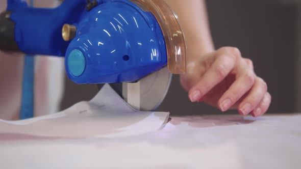 Cutting Cloth with an Automatic Circle Cutter in the Workshop